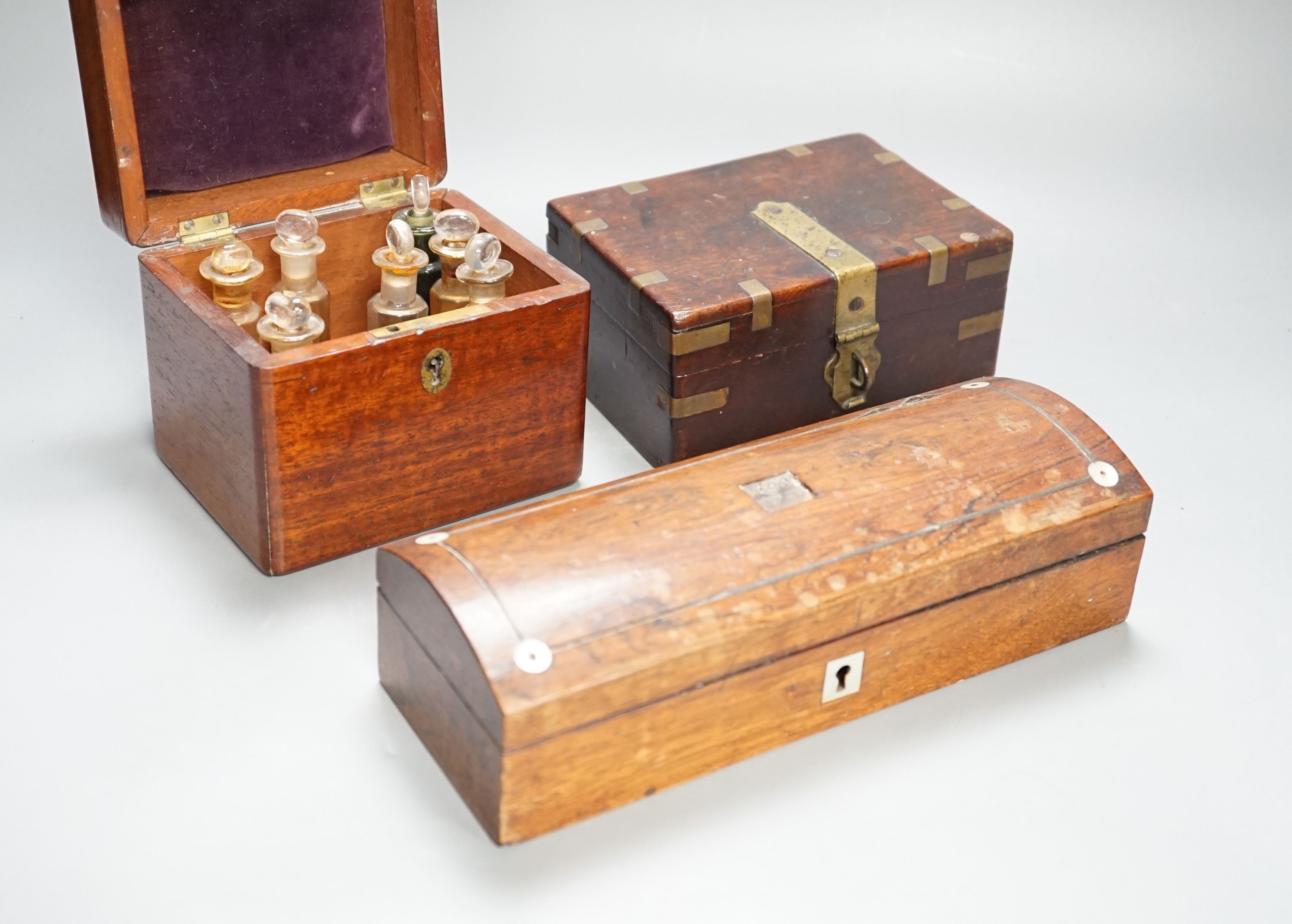 A Victorian mahogany medicine case, with bottles, 13cm. wide, a brass-mounted box and a rosewood veneered pen box